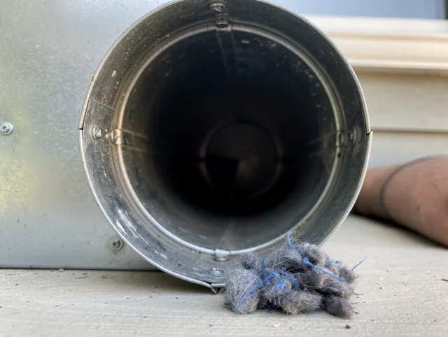 Bedford Heights Dryer Vent Cleaning technician using specialized equipment to clear severe dryer vent blockage in Bedford Heights